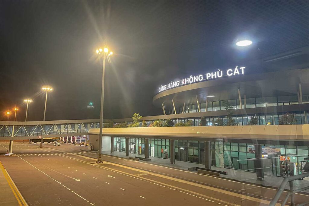 Night view of Phu Cat Airport (Quy Nhon Airport) with terminal lights and passenger facilities, the main gateway for flights to Quy Nhon city.