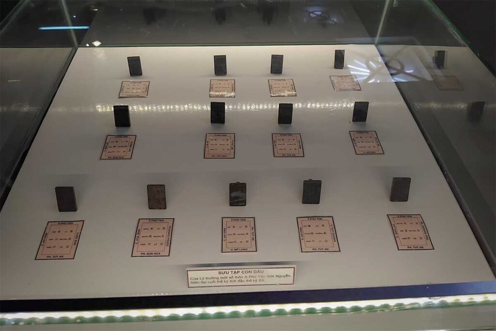 Collection of Nguyen dynasty-era official seals displayed in glass at Phu Yen Museum, linking Phu Yen to Vietnam’s administrative history.