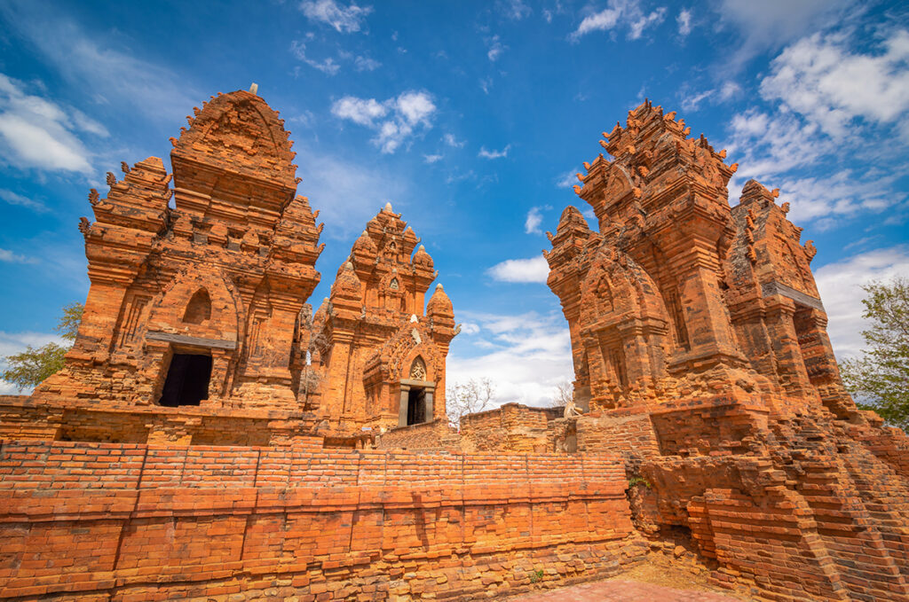 Close-up view of the red-brick Cham towers at Po Klong Garai complex, showcasing detailed carvings and ancient architecture.