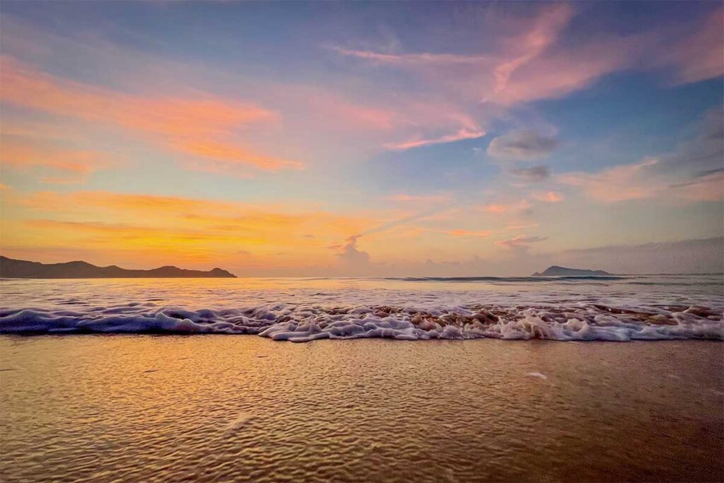 Early dawn colors and soft shore break washing onto Tu Nham Beach, Phu Yen.