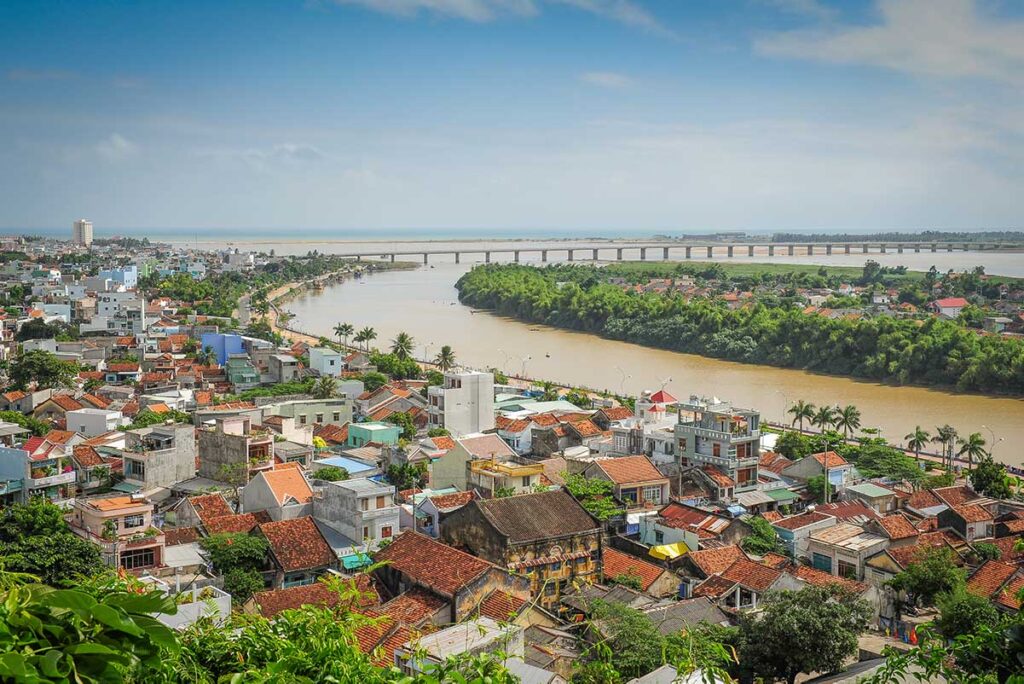 Panoramic view over Tuy Hoa city with the Da Rang River and long bridge stretching toward the South China Sea.