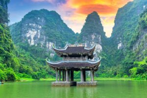 The floating temple of Tam Coc amid limestone cliffs in Ninh Binh at sunset — one of the scenic stops on our 3-week Vietnam itinerary through North and Central Vietnam.