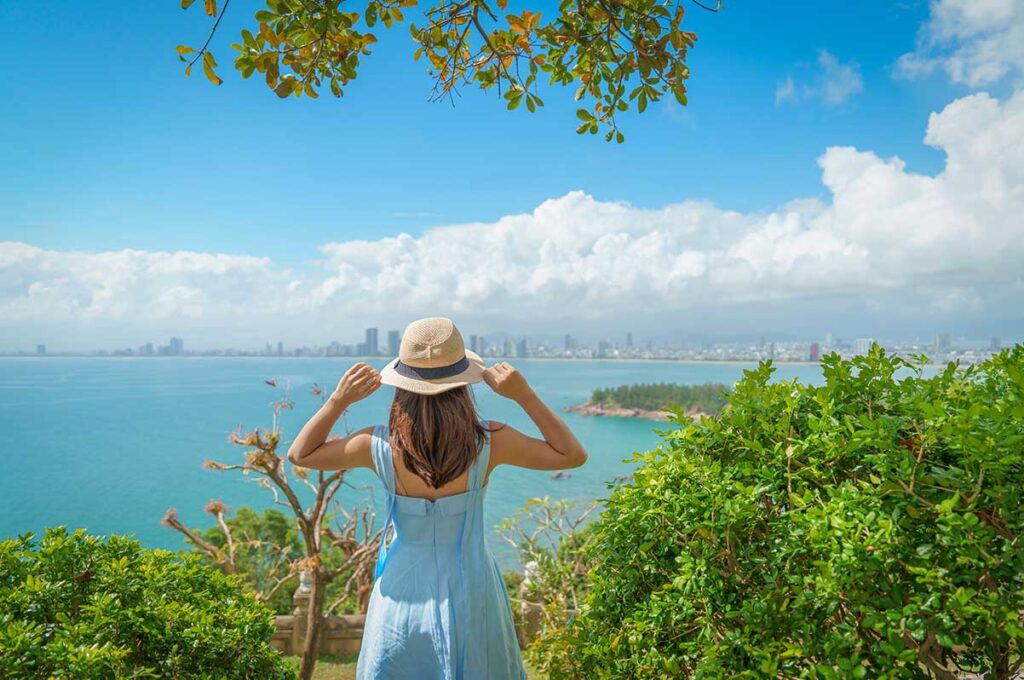 Traveler admiring the sea view from Son Tra Peninsula near Da Nang, a popular stop on coastal Central Vietnam tours.
