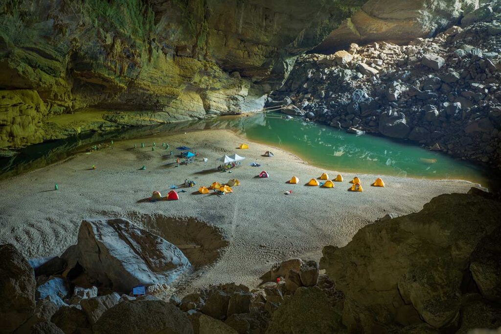 Camping inside Hang En Cave in Phong Nha-Ke Bang National Park, a top activity on Central Vietnam adventure tours.