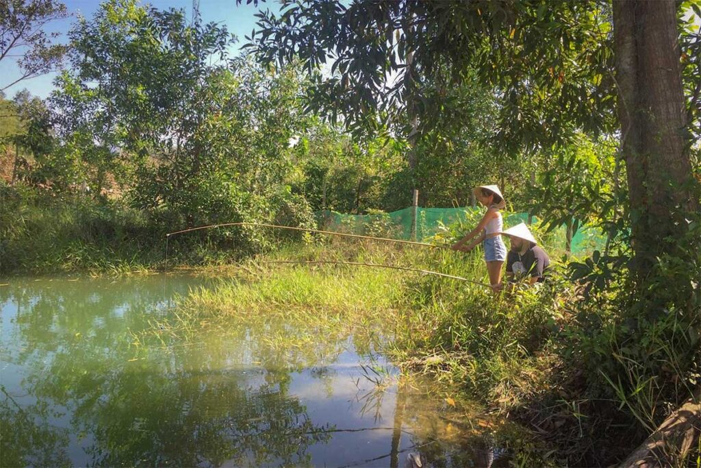 Visitors fishing at the pond on the grounds of Phu Quoc Countryside Pepper Farm