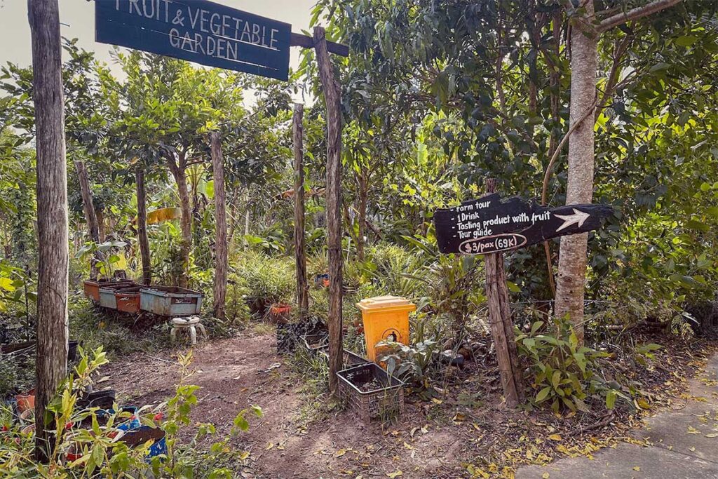 Entrance to the fruit and vegetable garden at Phu Quoc Countryside Pepper Farm with tour price signs