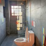 Bathroom of the Grand Suite at Ha Giang Aya Lodge with walk-in shower and stone tile walls.