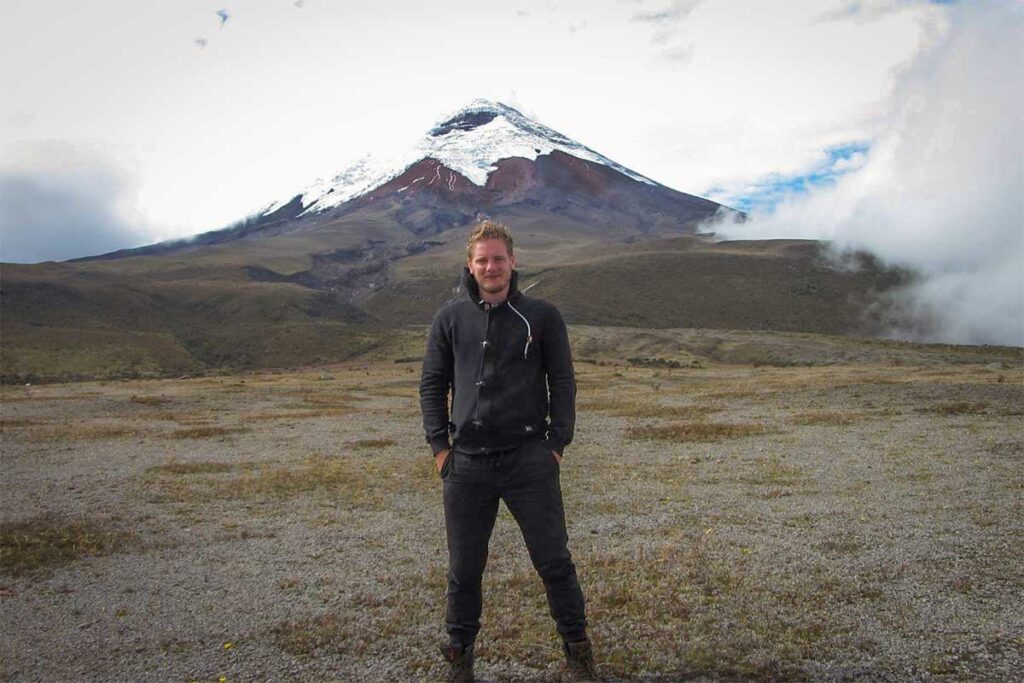 Marnick Schoonderwoerd, founder of Local Vietnam, standing at the base of Cotopaxi Volcano in Ecuador — showcasing years of global travel experience that shape his expertise as a professional travel advisor in Vietnam.