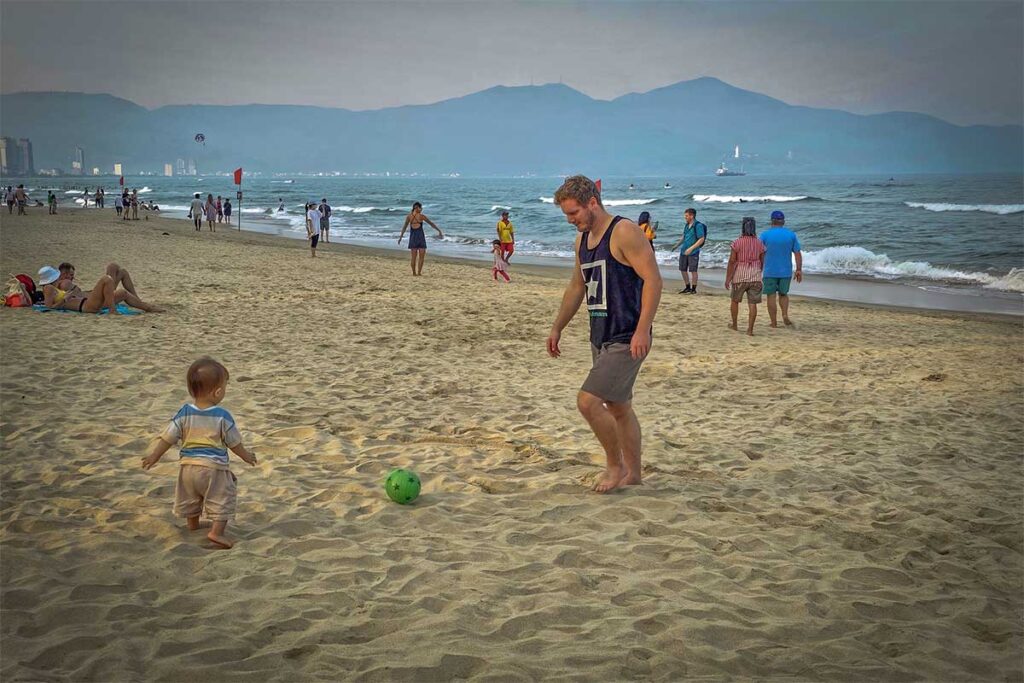 Marnick Schoonderwoerd enjoying daily life on Da Nang Beach with his son — living in Vietnam for over a decade and exploring its culture beyond tourism to guide travelers with real local insight.