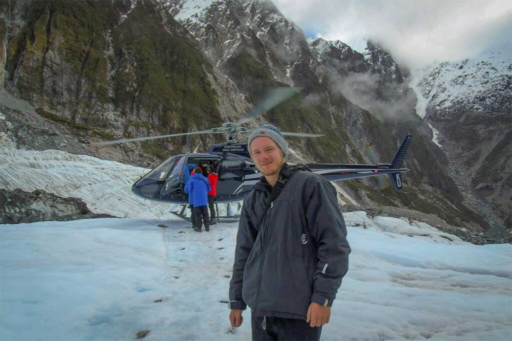Travel expert Marnick Schoonderwoerd during a helicopter glacier tour in New Zealand — highlighting his worldwide travel background that underpins the authentic and professional approach behind Local Vietnam.