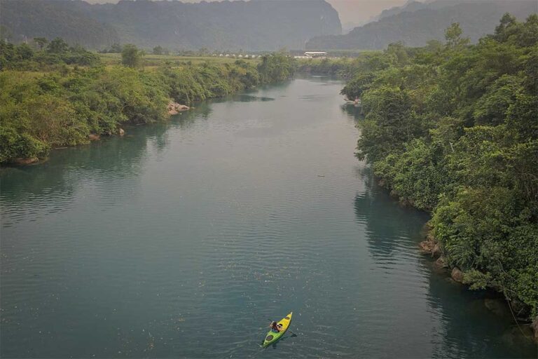 Nhung Phung kayaking through the rivers of Phong Nha – Ke Bang National Park, one of Vietnam’s most famous adventure destinations featured in Local Vietnam tours.