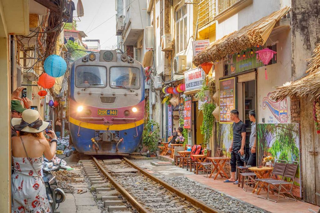 Train passing through Hanoi’s famous Train Street, a unique urban highlight often included in North Vietnam city tours.