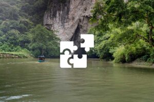 Private Ba Be Lake tour with a tailor-made itinerary, exploring calm river scenery, limestone cliffs, and lush jungle.