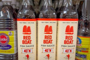 Bottles of Red Boat fish sauce made in Phu Quoc, Vietnam, sold on a store shelf in the United States