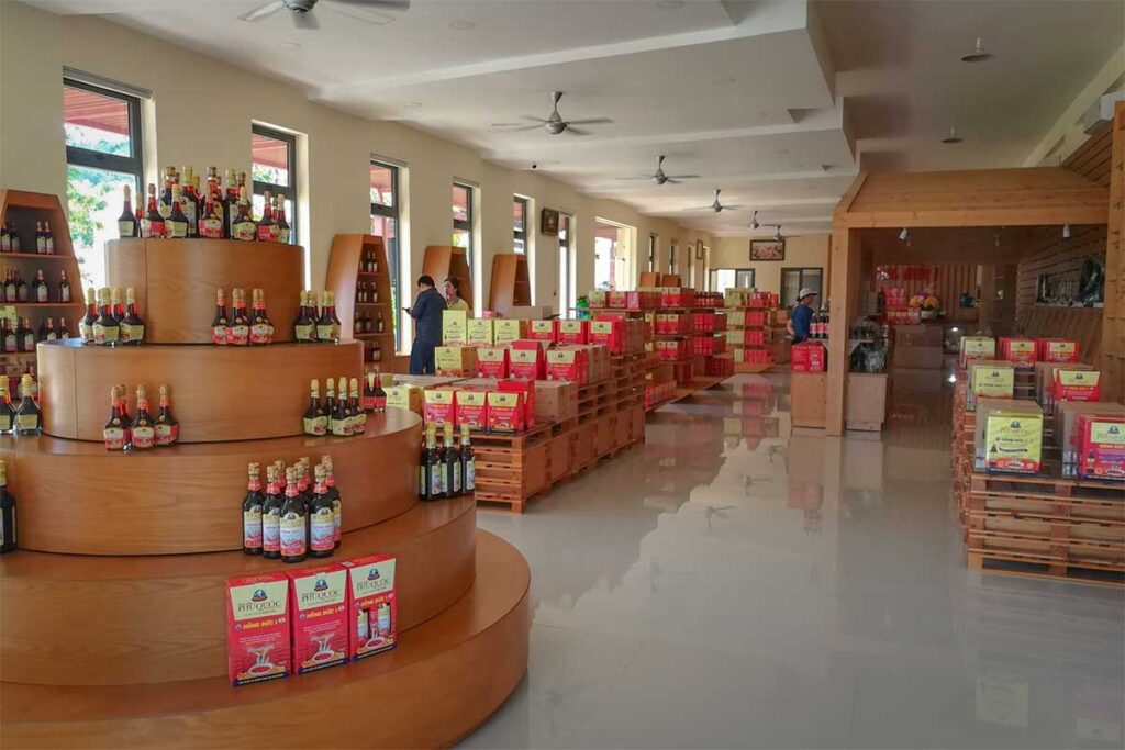 Well-stocked showroom at a Phu Quoc fish sauce factory, displaying various grades and gift sets of traditional Phu Quoc fish sauce