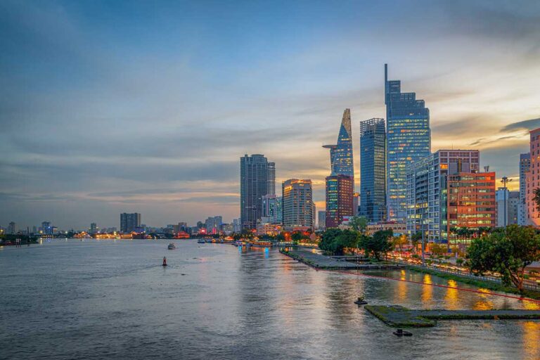 Modern skyline of Ho Chi Minh City along the Saigon River — a vibrant urban gateway and starting point for several Vietnam package tours.