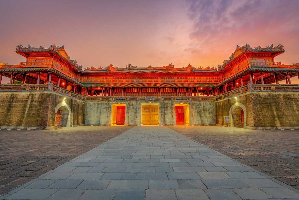 The illuminated Imperial City of Hue at sunset, showcasing Vietnam’s royal heritage and an essential stop on most Vietnam package tours.