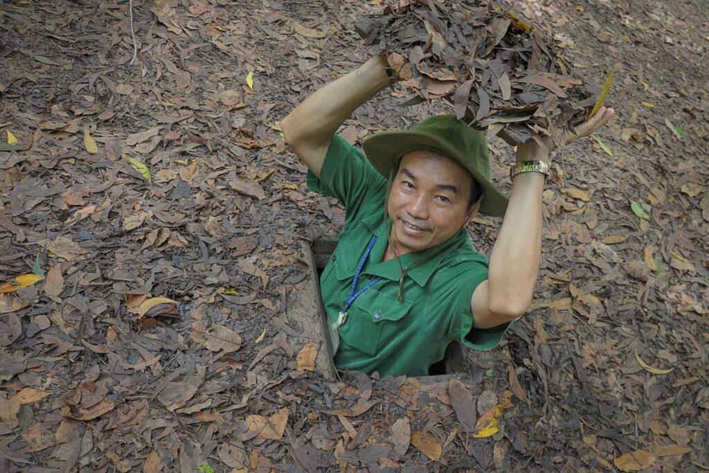 Licensed Vietnam tour guide demonstrating Cu Chi Tunnels near Ho Chi Minh City — historical guided tour in southern Vietnam.