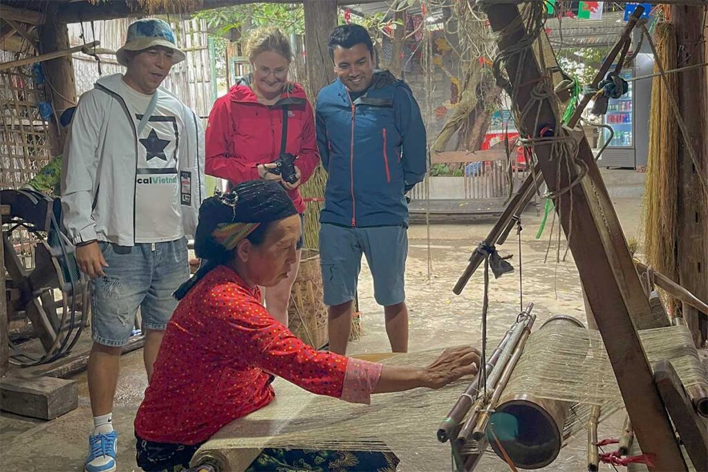 Local Vietnam guide and travelers visiting a traditional weaving village in northern Vietnam — cultural private tour experience.