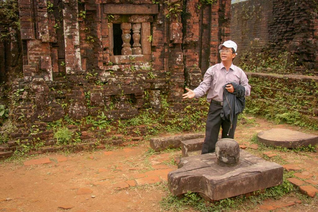 Professional Vietnam tour guide sharing history of My Son Sanctuary during a private escorted tour in Central Vietnam.
