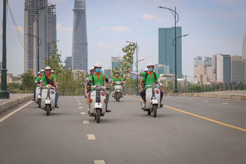 Guest riding as a passenger on a Hanoi motorbike tour with Local Vietnam at night, captured in the Old Quarter area and showing authentic evening street life, crowds, and real city conditions.