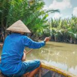 Hoi An basket boat tours riding traditional round bamboo boats through coconut palm waterways near Hoi An