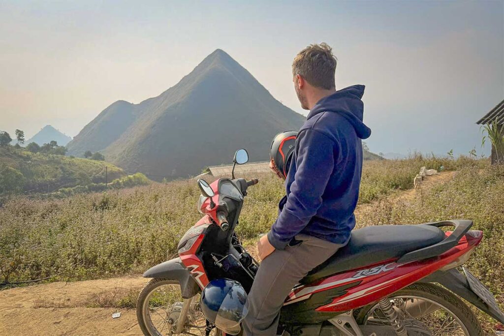 Local Vietnam founder exploring remote Ha Giang landscapes by motorbike while researching trekking and tour routes, showing first-hand destination knowledge and on-the-ground experience.