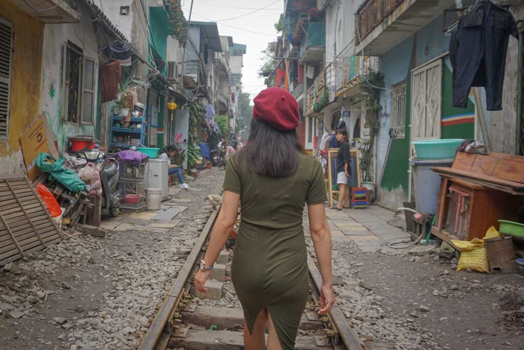 Nhung, founder of Local Vietnam, walking along Hanoi Train Street before it became popular, exploring the area during early research trips long before cafés and mass tourism arrived.