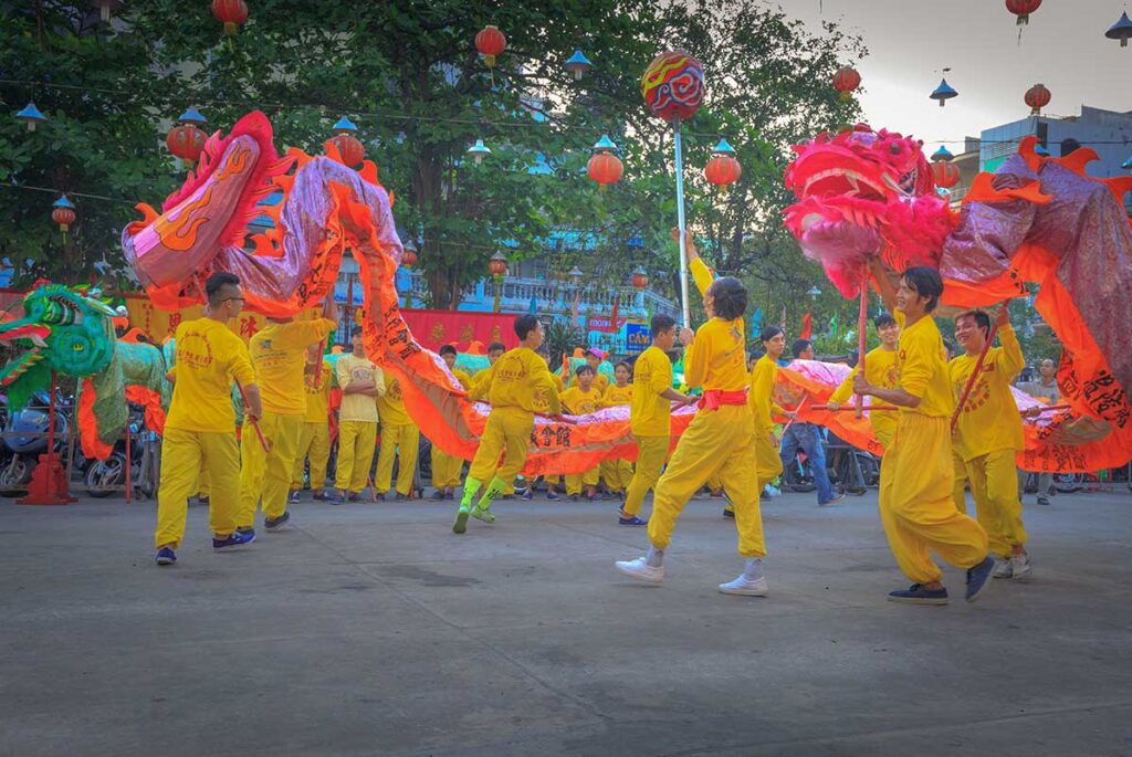 Vietnamese dragon dance with the symbolic pearl guiding the dragon’s movement, representing wisdom and harmony during the performance.