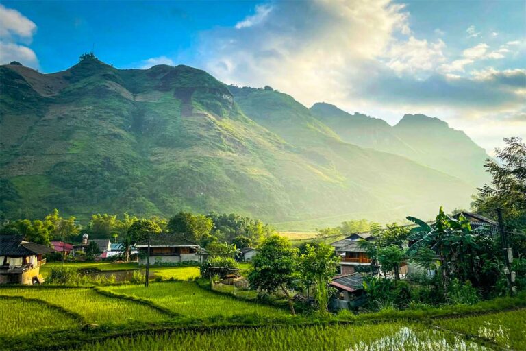 Du Gia village scenery on the Ha Giang Loop tour by Local Vietnam, showing rice fields, local houses and mountains visited as part of a multi-day Ha Giang Loop car and jeep itinerary