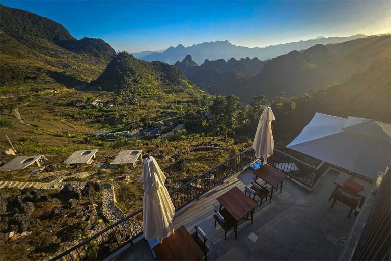 Mountain views from the restaurant terrace at Ha Giang Aya Lodge, overlooking valleys and peaks along the Ha Giang Loop