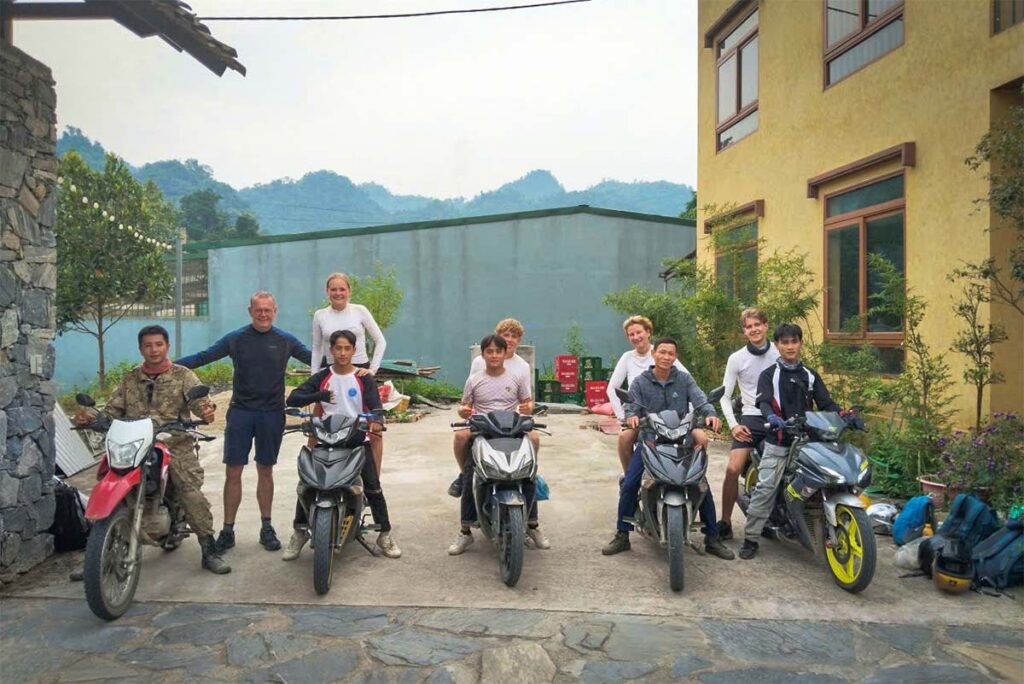 Family-friendly Ha Giang Loop Easy Rider tour with Local Vietnam, showing guests and local drivers on motorbikes at a homestay stop during a guided Ha Giang motorbike tour