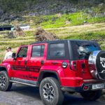 Ha Giang Loop by jeep experience with a modern 4x4 vehicle on scenic mountain roads in northern Vietnam