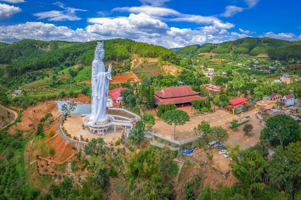 Drone view of Linh An Pagoda near Dalat showing the giant Lady Buddha statue, temple complex and surrounding green highlands