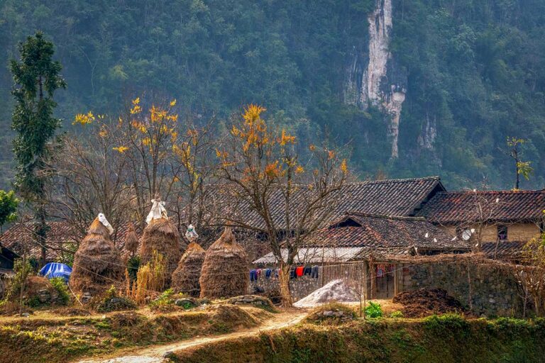 Most beautiful places in Vietnam, with a traditional village in Ha Giang set among limestone mountains, wooden houses, and rural northern landscapes.