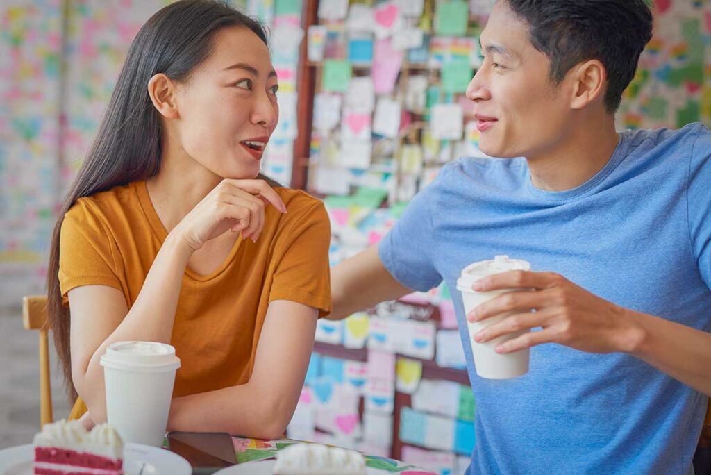 Vietnam couple holiday package enjoying a relaxed café moment in Hanoi, highlighting everyday experiences and easy-going travel as part of a romantic Vietnam trip