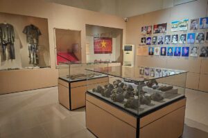Museum room displaying historical artifacts, weapons and portraits of revolutionary figures connected to Con Dao prison history.