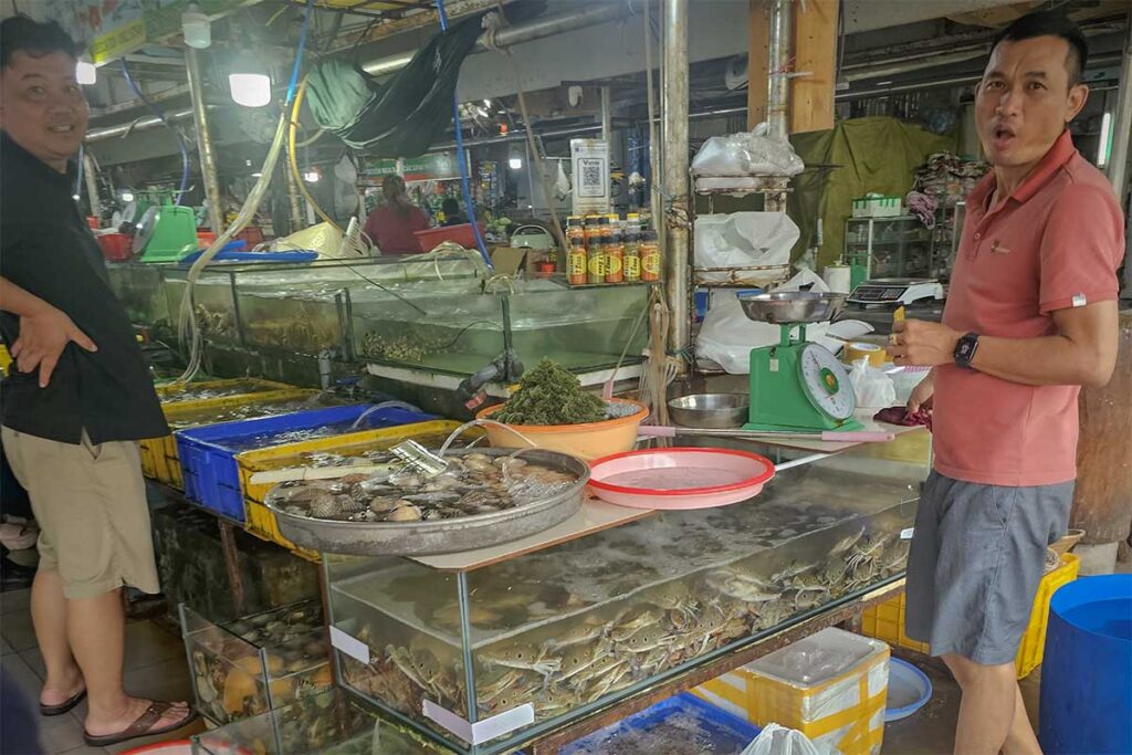 Live seafood tanks at Con Dao night market with crabs, shellfish and fish ready to be selected and cooked on the spot