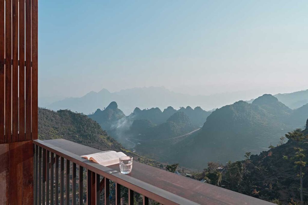 View from the balcony at Ha Giang Aya Lodge overlooking the limestone mountains and valleys of the Ha Giang Loop.
