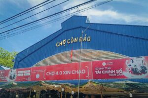 Front view of Con Dao Market building with blue roof and local signage, located in the center of Con Son Town