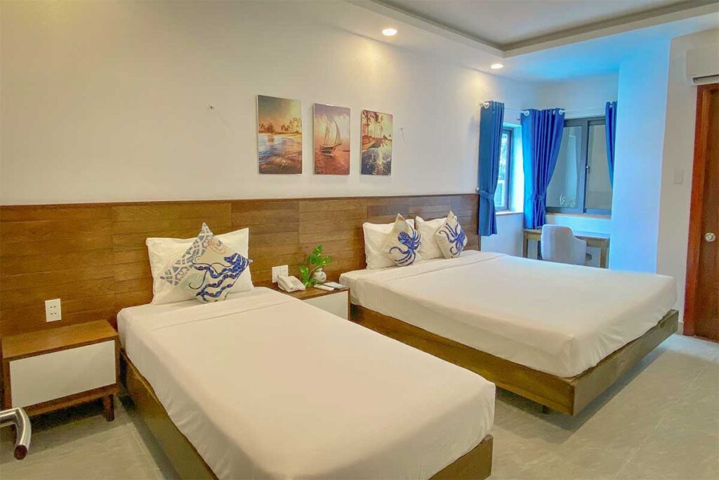 Twin room at Nicobar Con Dao Hotel with clean design, comfortable beds, and natural light