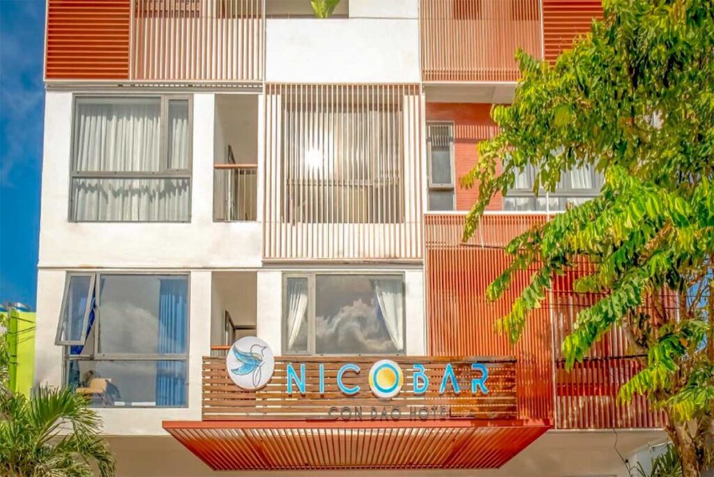 Exterior of Nicobar Con Dao Hotel in town center with modern design and colorful facade
