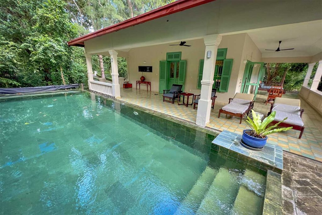 Private pool villa at Poulo Condor Boutique Resort Con Dao with outdoor terrace, sun loungers, and tropical garden setting
