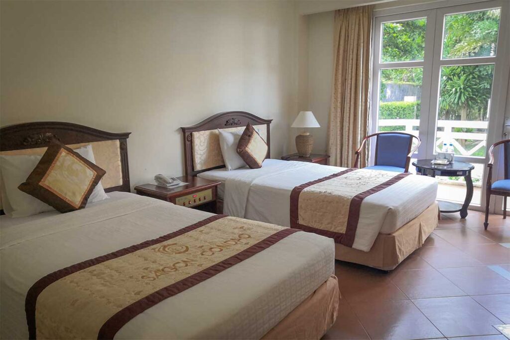 Twin room at Sai Gon Con Dao Resort with classic furnishings, balcony access, and garden view