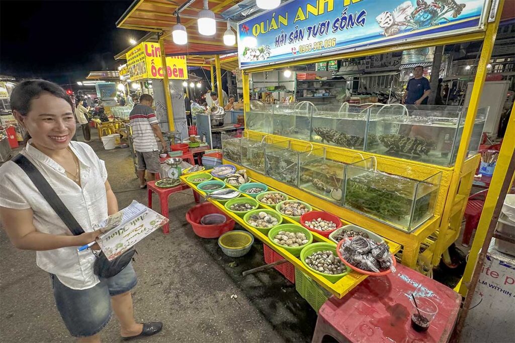 Live seafood tanks at Con Dao night market with crabs, shellfish and fish ready to be selected and cooked on the spot