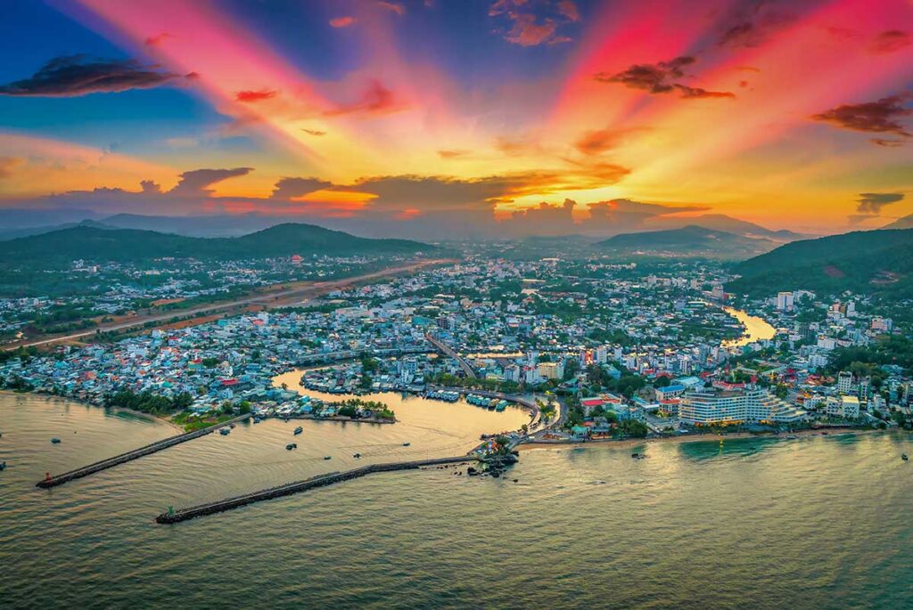 Aerial view of Duong Dong town Phu Quoc with river harbor coastline and colorful sunset sky