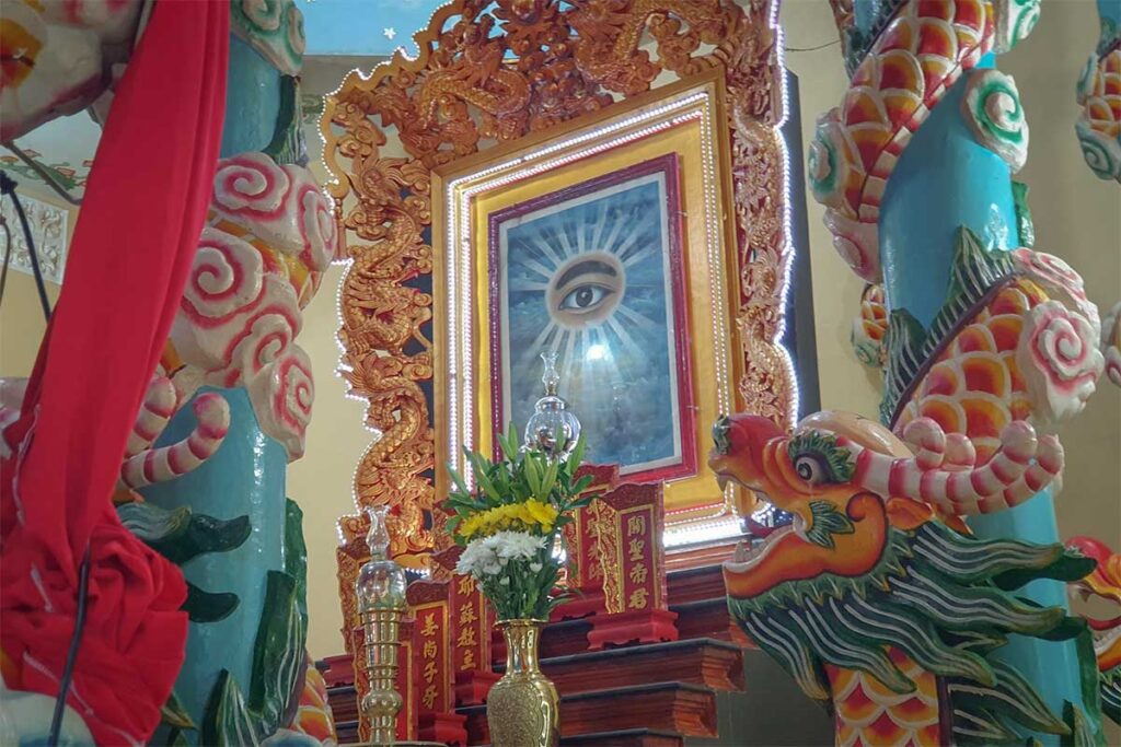 Divine Eye altar inside Cao Dai Temple in Phu Quoc with ornate decorations and symbolic dragon details