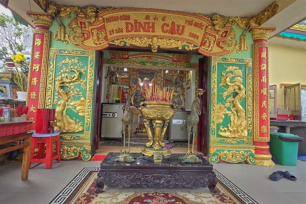 Interior altar inside Dinh Cau Temple in Phu Quoc with incense and ornate decorations