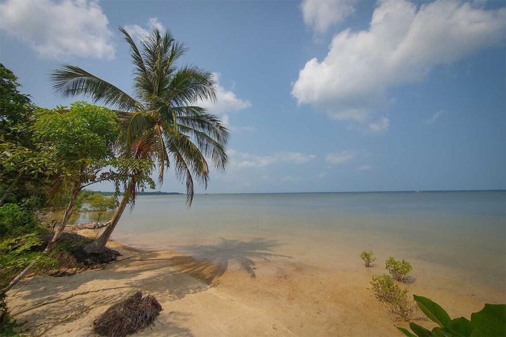 Bai Bon Beach Phu Quoc quiet tropical shoreline with palm trees shallow water and blue sky