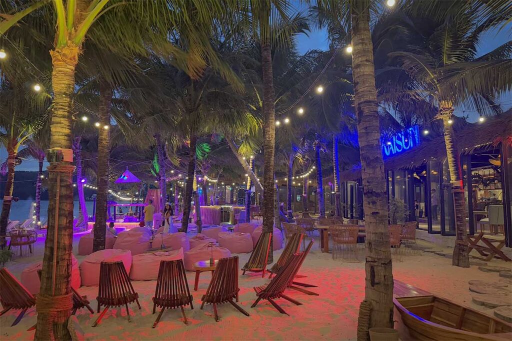 Bai Khem nightlife beach bar in Phu Quoc with palm trees lights beanbags and evening atmosphere